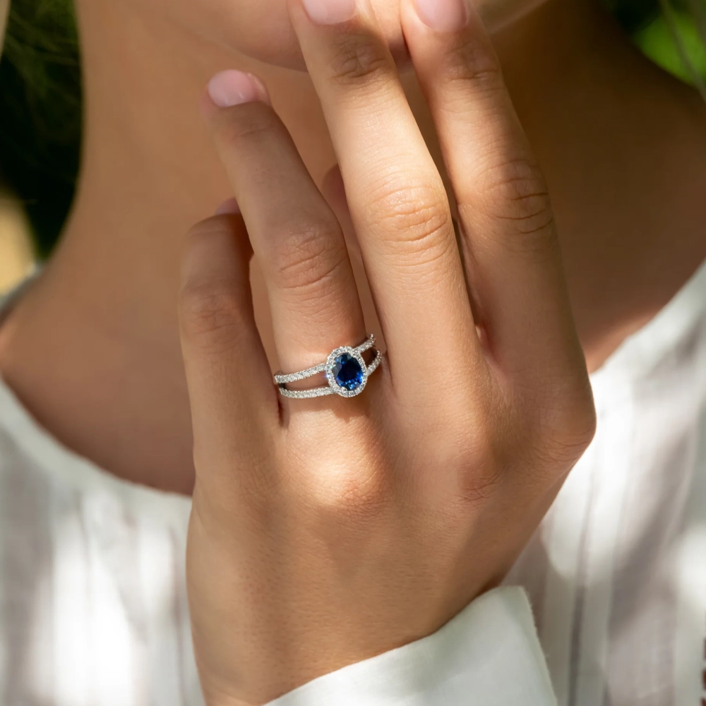 Sapphire engagement ring worn on hand representing loyalty, clarity, and devotion